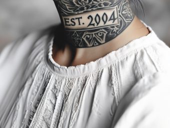 A woman with an Est. 2004 tattoo on her back shoulder